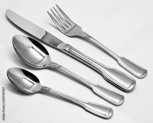 Quadro su tela Premium stainless steel cutlery set including forks, spoons and knives arranged on a white background for kitchenware catalog, ecommerce and restaurant dining concepts