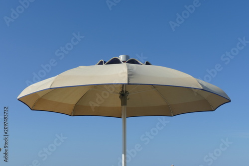 Beach Sunbeds and Closed Umbrellas on a Sandy Resort Coast