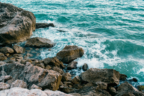 Seascape layers: rocks and crashing waves on the Mediterranean coast in Garraf, Catalonia, Spain