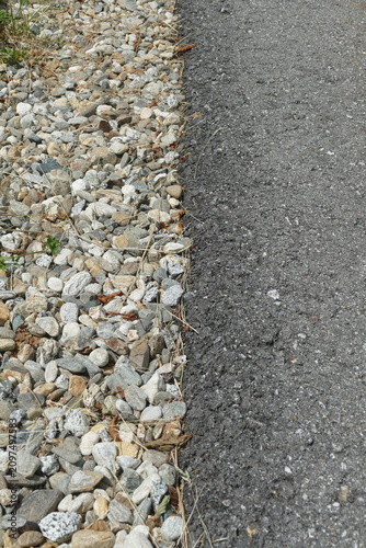 Border Between Asphalt Road and Gravel Path