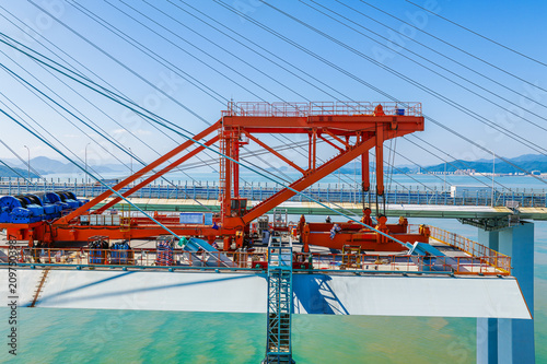 Obraz na plátně Bridge girder launcher crane installing a steel segment on a cable-stayed bridge