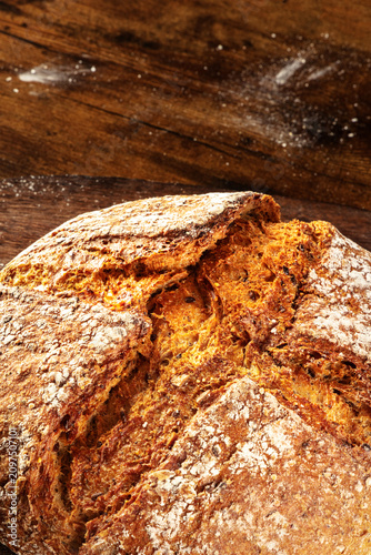 Homemade artisan sourdough bread loaf on a rustic wooden cutting board