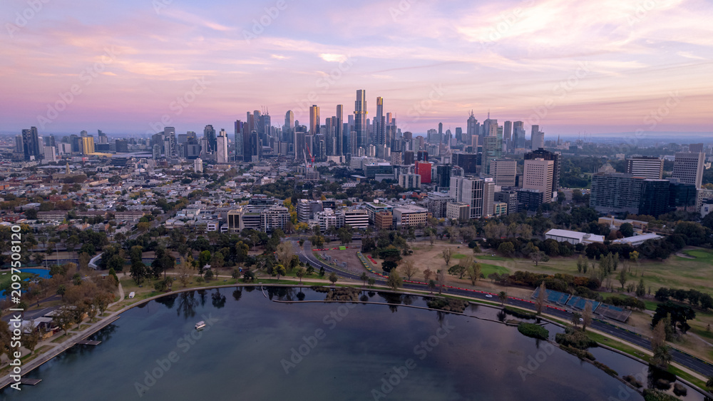 Fototapeta premium Sunrise view of Yarra river and Melbourne skyscrapers business office building with evening skyline in Victoria, Australia