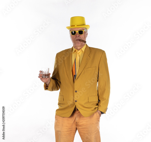 Fotografie Businessman man with cigar in yellow suit isolated on white background