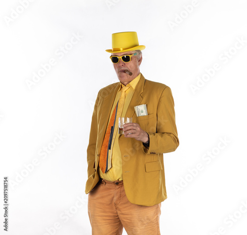 Fotografi Businessman man with cigar in yellow suit isolated on white background