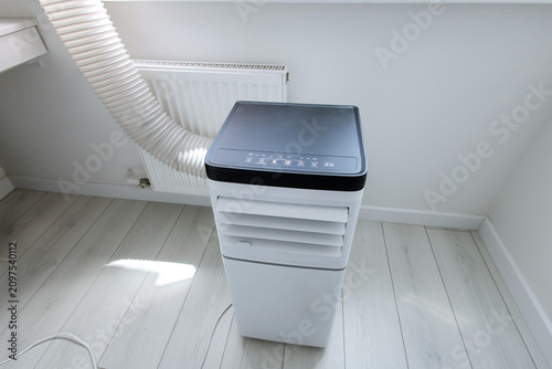 High-angle view of smart mobile monoblock air conditioner unit with electronic control panel and led icons