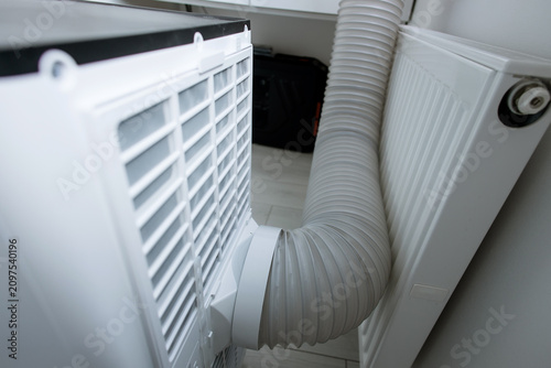 Bild auf Leinwand Backside view of mobile monoblock air conditioner showing air intake filter mesh