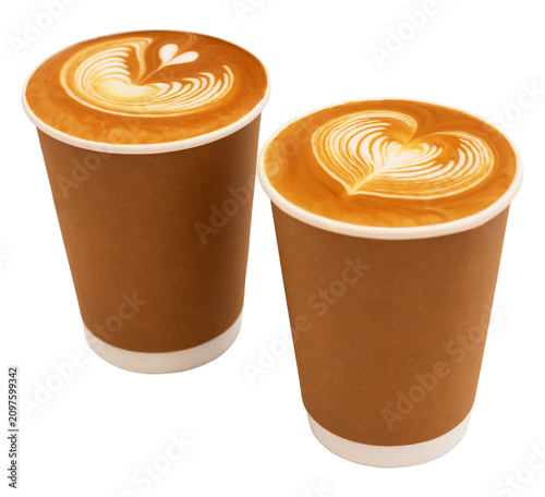 Coffee. Two disposable coffee cups featuring intricate latte art designs on surface, with brown paper exterior and white plastic bottoms, positioned side by side. Isolated