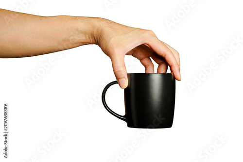 man holding a black ceramic mug with a handle against a white background.