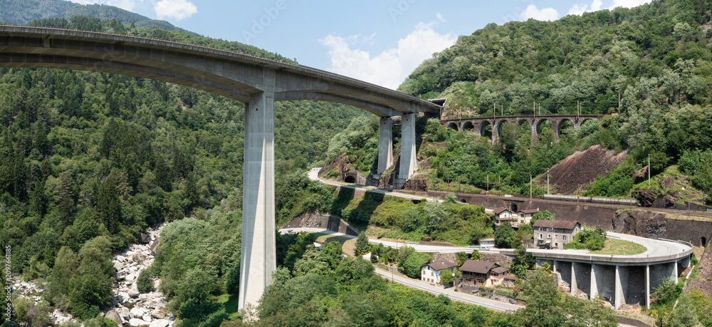 Obraz premium Highway bridge in Ticino between Giornico and Lavorgo, with an aerial shot you can see all the communication routes, railway, highway and old cantonal road