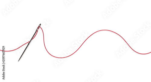 A sharp metal sewing needle with a long red thread on a white background