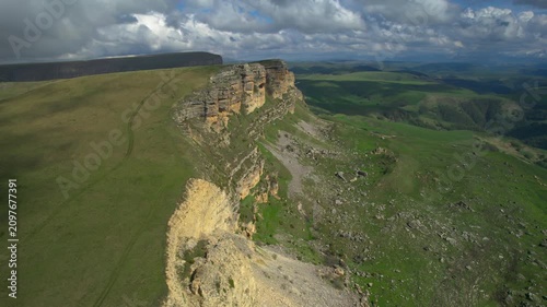 Aerial view of a mountain plateau with high cliffs. Landscape and nature of the North Caucasus.