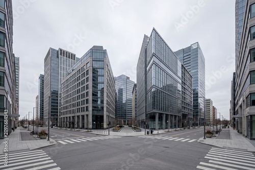 Empty city street intersection with zebra crosswalk and modern office buildings