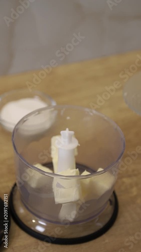 Putting butter in a blender and sugar