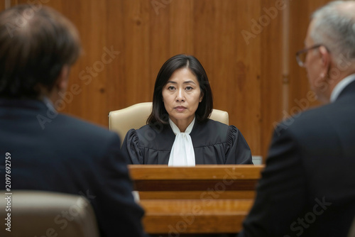 Portrait of woman Asian female judge listens to lawyers in the courtroom during a break in the trial