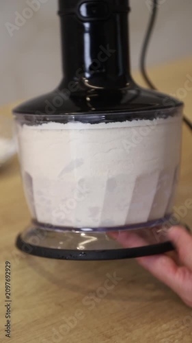 Mixing ingredients butter and flour in a crumb by blender