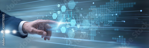 Photos Insurance broker quickly touching virtual tablet analyzing Insurtech algorithms across the claims processing network framework