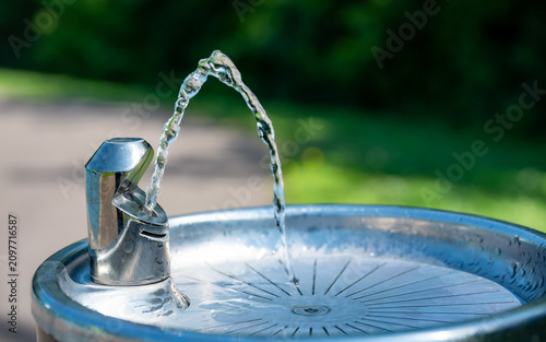 Konstfotografi Outdoor drinking fountain with streaming water in public park