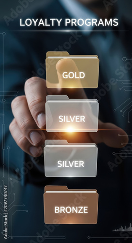 Metaverse Business Models Concepts. Businessman selecting digital loyalty program tier gold silver bronze on virtual screen interface for membership benefits