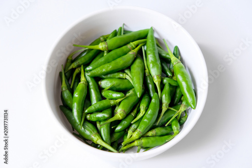 Obraz na plátně Fresh green bird's eye chilies or cabe rawit hijau in a white bowl for culinary