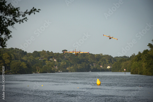 View of the Canadair water bombers scooping water from the Seine during the fires in the Fontainebleau forest