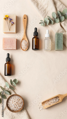 Premium Flat Lay of Natural Herbal Skincare Products with Botanical Soaps, Amber Serum Bottles, Bath Salts, and Fresh Greenery on Soft Pastel Background for Clean Beauty and Wellness Branding