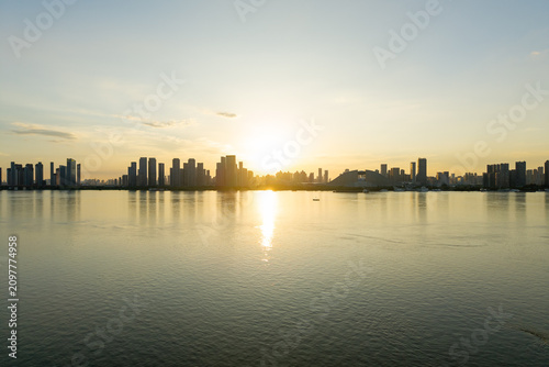 Photos The sun rises over the modern city skyline of Wuhan China reflecting beautifully