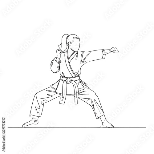 A female martial artist in a fighting stance with one arm extended
