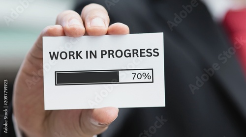 Photography Businessman showing a work in progress status bar at seventy percent completion