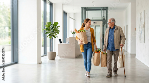 Friendly neighbor helping senior man carry grocery shopping home