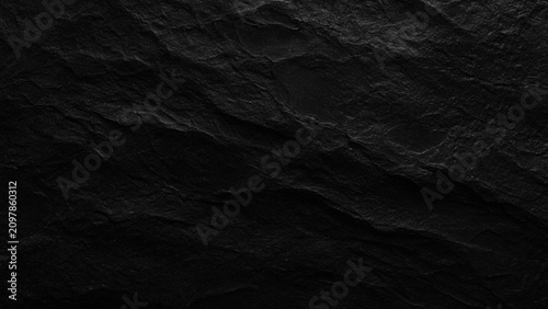 Photos Dark rough stone texture with jagged surface and natural rock formation patterns