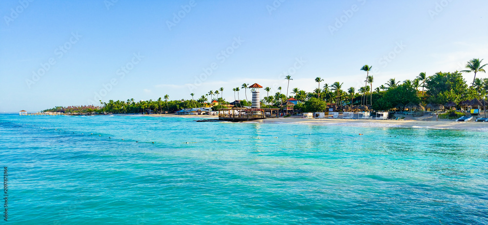 Obraz premium Dominicus beach with white sand, palms and light house. Dominican republic 