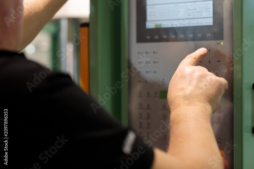 operator controls machine with the control panel