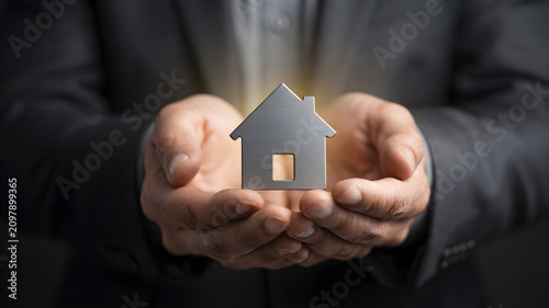 Home Investment Protection Concept with House Icon in Caring Hands. Concept: Real Estate Investment, Home Ownership, Property Protection, Mortgage, Home Insurance, Housing Security, Property Managemen