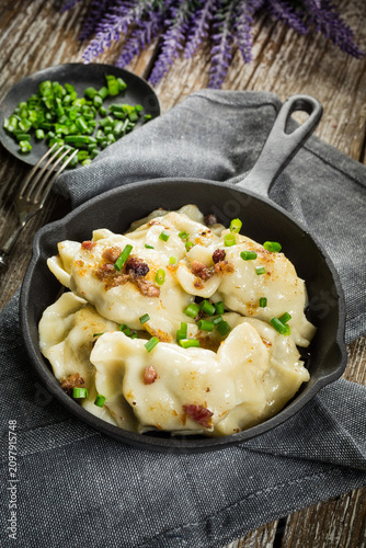 Fried dumplings (pierogi) with meat filling sprinkled with greaves.