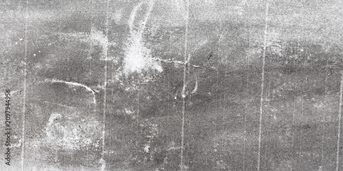 Fotografía A close-up, high-angle shot reveals the textured surface of a rough concrete wall with visible cracks and weathered patches, suggesting age and urban decay
