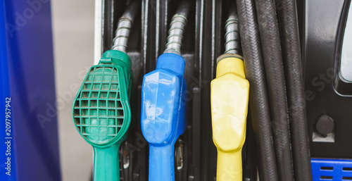 Foto Close up of colorful fuel pump nozzles at a gas station