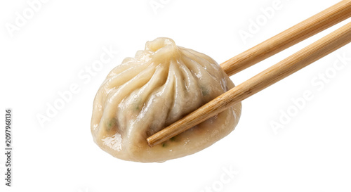 Steaming hot soup dumpling held delicately by bamboo chopsticks, ready to eat