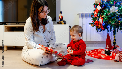 Mother and baby enjoy Christmas morning gifts