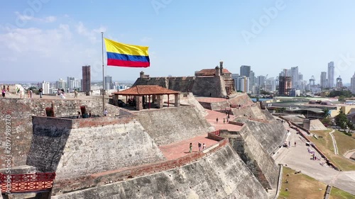 Сartagena de indias, Сolombia  - MARCH 20, 2026: Aerial Drone View of Castillo San Felipe de Barajas: Historic Spanish Fortress with Waving National Flag and Modern Skyline