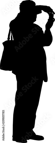 Black silhouette of a man taking a photo with a smartphone isolated on a white background, standing and using a mobile phone camera