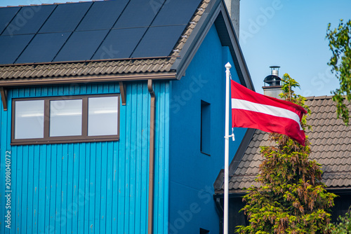 Foto Latvian flag waving beside house