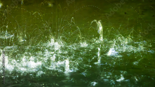 Tableau sur toile Abstract water splash and bubbles with light reflection in a natural forest pool