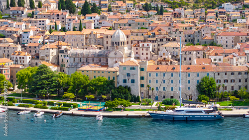 Scenic view of Sibenik old town with Cathedral of St. James and luxury yacht moored at the Adriatic coast in Croatia