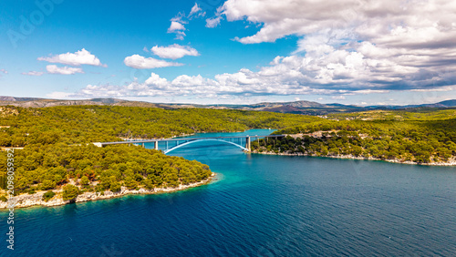 Tableau sur toile Aerial view of the Krka River bridge in Croatia, surrounded by lush green forest