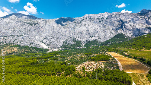 Quadro su tela Aerial view of Biokovo mountain range and green landscape in Croatia