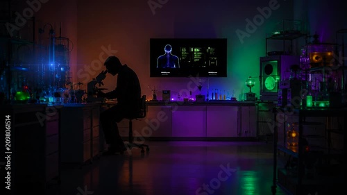 Scientist looking into microscope long shot science setting
