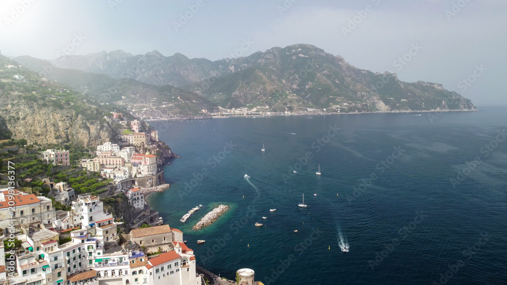 Obraz premium High altitude drone capture of Amalfi town and rugged coastline in Campania