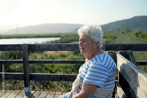 Healthy aging and senior lifestyle elderly woman enjoying nature outdoors on a sunny day retirement and well-being