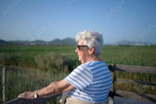 Healthy aging and active senior lifestyle elderly woman enjoying nature outdoors with a serene expression